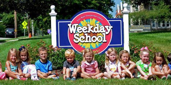 Weekday School students sit in front of the sign on the campus of Bryn Mawr Presbyterian Church